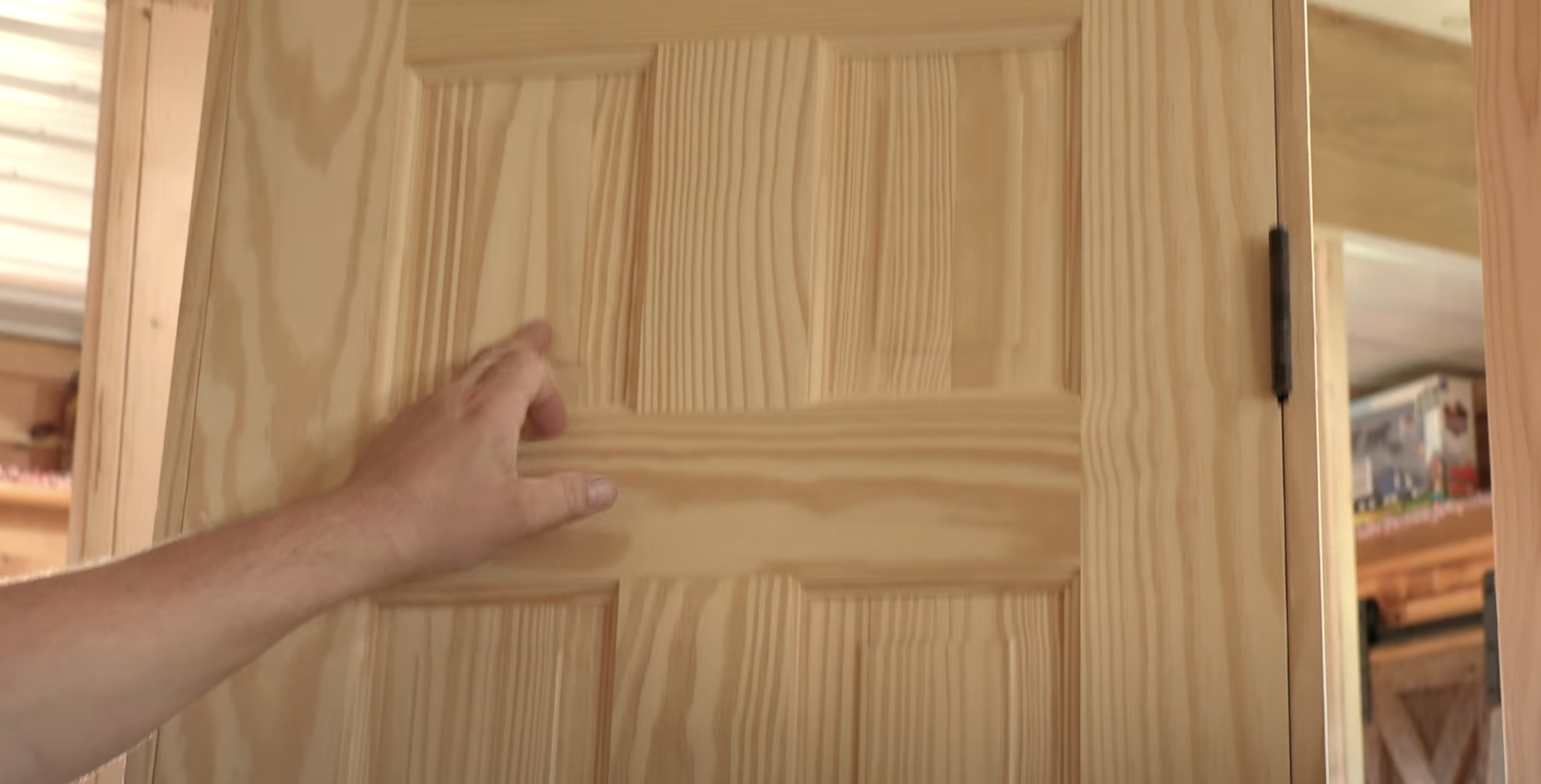 A company sales person shows off wood detail in a showroom during a video shoot.