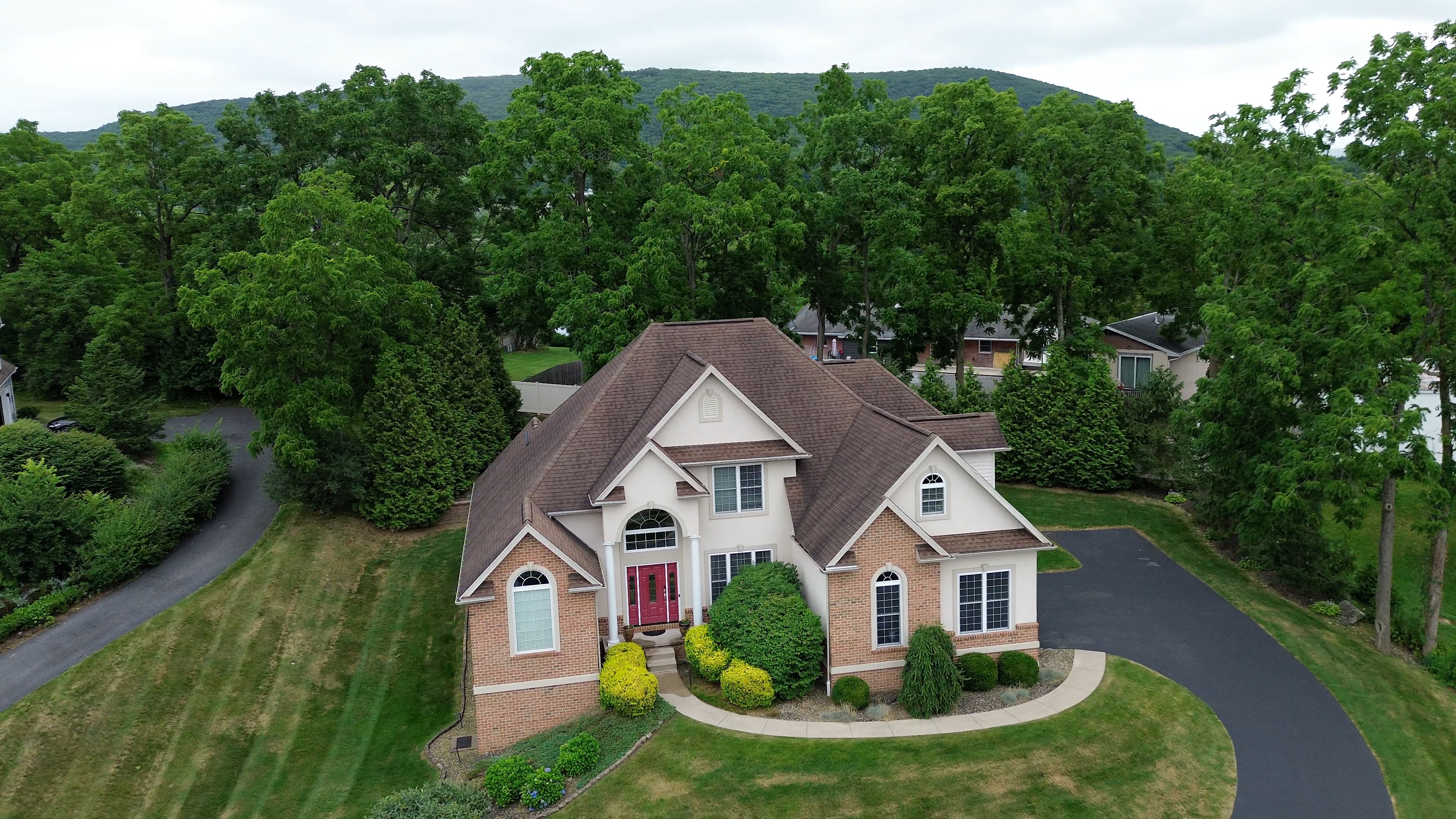 A photo taken from a drone in State College shows the width of Nittany Mountain in the background.